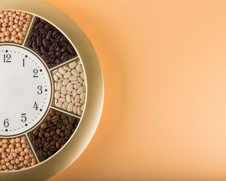 Decorative wall clock with bean. Diet concept