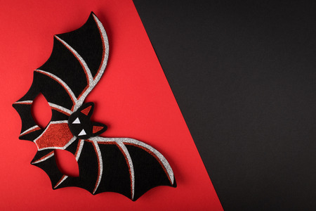 Halloween black-red background with bat mask