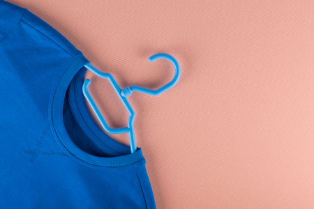 Blue long sleeve t-shirt on a plastic hanger. Store conceptの写真素材