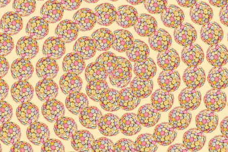 Spiral of multicolor flower balls on a light yellow background