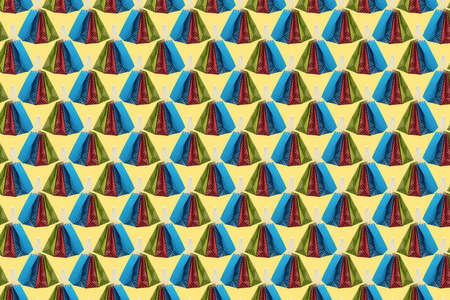 Abstract background composed of colored paper gift bags on a yellow background, shopping conceptの写真素材