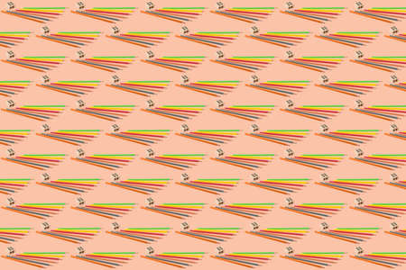 Abstract background composed of repeating colored pencils and sharpener, school concept