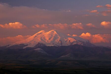 Mountain tops is illuminated by the first rays of the sunの写真素材