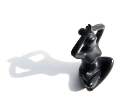 Plastic women in lotus pose isolated against white backgroundの写真素材