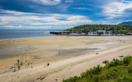The sandy beach and marina of the Tadoussac Bay on a beautiful summer (Quebec, Canada)のeditorial素材