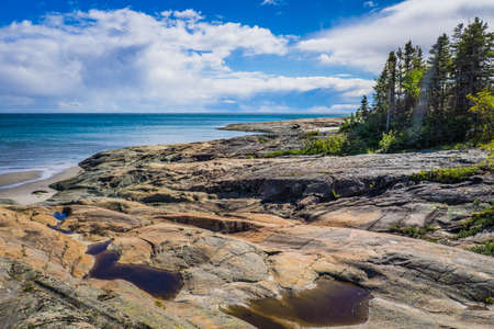 Rocky shoreline on the St Lawrence river near Raguneau in Cote Nord of Quebec, Canadaの写真素材