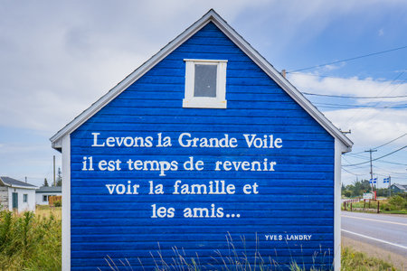 Blue house with poems at the entrance of the small fishing town of Natashquan, in Cote Nord region of Quebec (Canada)のeditorial素材