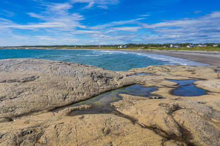 Rocky bay of Saint Lawrence Estuary in Riviere-au-Tonnerre, a small village located in Cote Nord region of Quebec, Canadaの写真素材