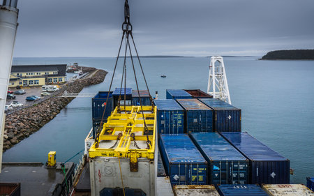 Containers being loaded on the Bella Desgagne, a ship travelling on the St Lawrence river, providing maritime transport services to Anticosti Island and the Quebec Cote Nordのeditorial素材