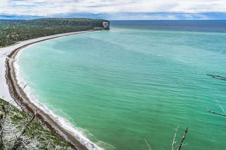 View on the turquoise waters and the cliffs of Anse du Sentier Vert from the Sentinelles hiking trail in Anticosti national park, located on a island of the St Lawrence estuary in Cote Nord regionの写真素材