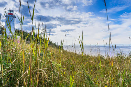 View from in between the grass on the abandoned Pointe Carleton lighthouse on Anticosti island, in Cote Nord region of Quebec, Canadaの写真素材