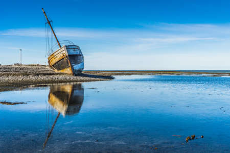 Reflection of the "Calou" shipwreck on a clear summer morning on Anticosti island, an island located in the St Lawrence river, in Cote Nord region of Quebec, Canadaのeditorial素材