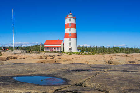 View on the Pointe des Monts lighthouse, the most famous lighthouse of Cote region of Quebec, Canadaのeditorial素材