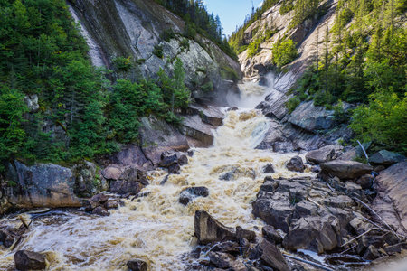 View on the MacDonald waterfall, a big fall located in the Port Cartier reserve, in Cote Nord region of Quebec, Canadaの写真素材