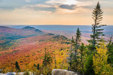 View on the mountains and the fall foliage of Mont Megantic National park from a belvedere along the "Sentier des Cimes" hiking trail, in Eastern Townships, Quebec, Canadaの写真素材