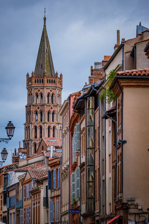 View on Saint Sernin Basilica bell tower from a street in Toulouse old town (South of France)のeditorial素材