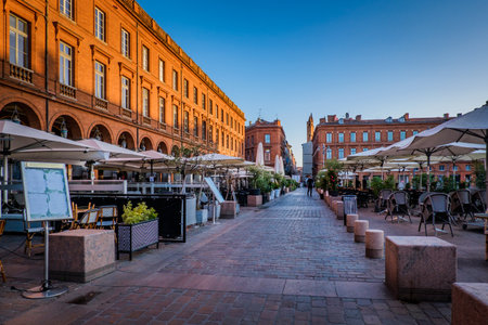 Chairs, tables and sunshade of a cafÃ© terrace on the Capitole square in Toulouse in the south of France (Haute Garonne)のeditorial素材