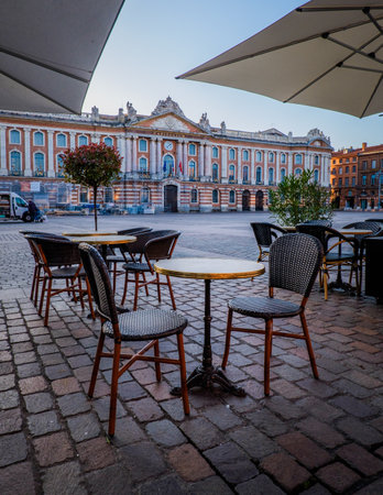 Chairs, tables and sunshade of a cafÃ© terrace on the Capitole square in Toulouse in the south of France (Haute Garonne)のeditorial素材