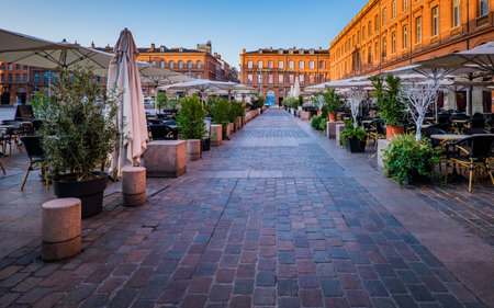 Chairs, tables and sunshade of a cafÃ© terrace on the Capitole square in Toulouse in the south of France (Haute Garonne)のeditorial素材