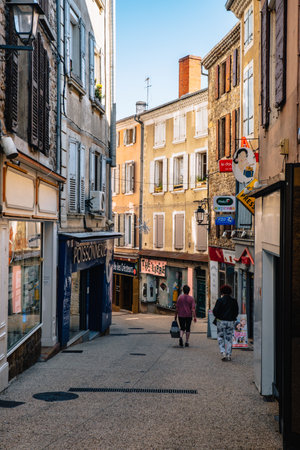Rue de Deume, a narrow street with shops and colorful ochre coated facades in the old town of Annonay, in the south of France (Ardeche)のeditorial素材