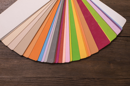 Colorful color paint catalogue on wooden deskの写真素材