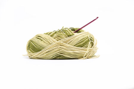 Green and yellow yarn with needleの写真素材