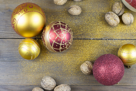 Christmas balls and nutmegs on a old wood boardの写真素材
