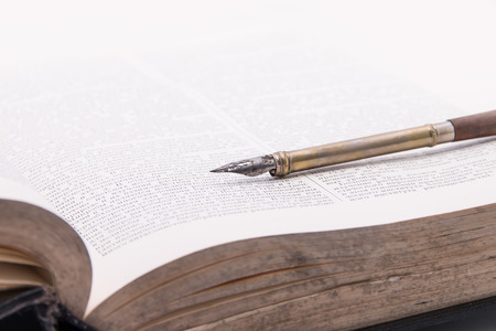 Fountain pen on an antique old bookの写真素材