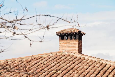 Chimney on the roof of the old houseの写真素材