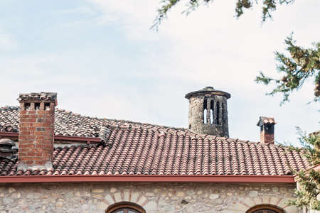 Chimney on the roof of the old church. Blue sky with copy spaceの写真素材