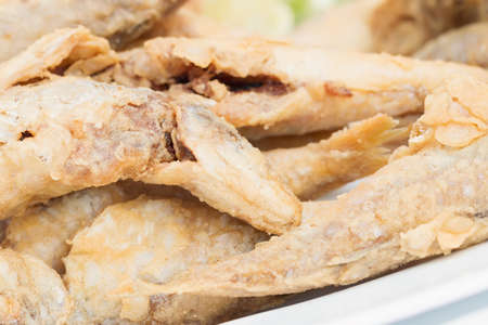 Small dish of fried whitebait with slices of lemonの写真素材