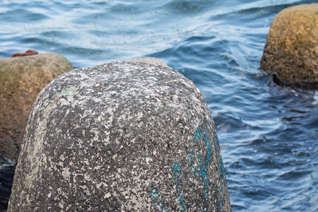 Close up of breakwater tetrapod in water backgroundの写真素材