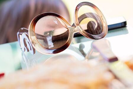 Eye glasses on glass table on white backgroundの写真素材