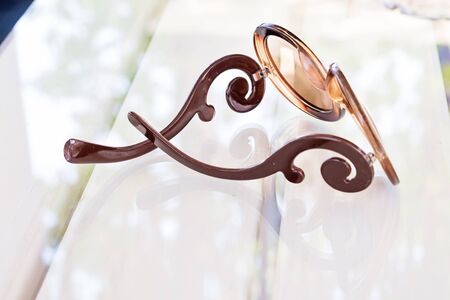 Eye glasses on glass table on white backgroundの写真素材