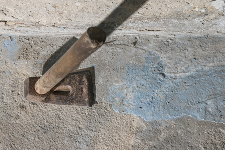 Old weathered grunge adze against cement wall with copy space