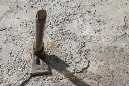 Old weathered grunge adze on cement floor with copy spaceのeditorial素材