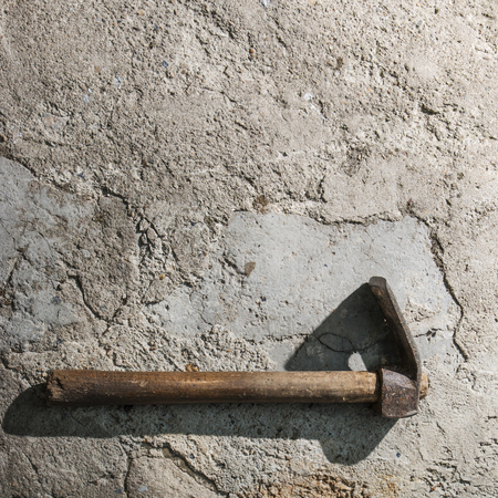 Old weathered grunge adze on cement floor with copy space