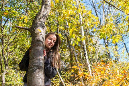 Portrait of a young woman in autumn parkの写真素材