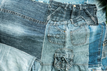 remnants of old jeans trousers folded like a collageの写真素材