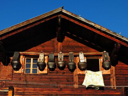 Facade of a old farmhouse and big cow bellsのeditorial素材