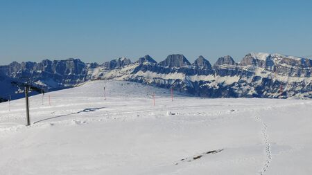 Ski lift and Churfirsten, mountain range in the Swiss Alpsの写真素材