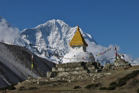 Stupa and snow capped mountain Thamserkuの写真素材