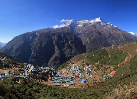 Village and holiday resort Namche Bazar. Snow capped mountain. Scene in the Everest National Park, Nepal.の写真素材