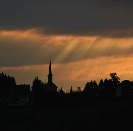 Sunbeams over a small church. Seegraben, Switzerland.の写真素材