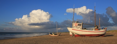 Fishing boat and summer clouds in the Jammerbugten, Denmark.