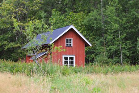Red shed and forest in Dalsland; Sweden.