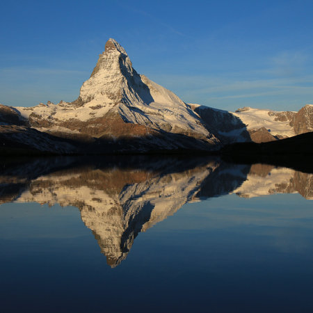 Snow capped Mount Matterhorn reflecting in Lake Stellisee.の写真素材