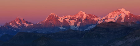 Eiger, Monch and Jungfrau in pink evening light, Switzerland.の写真素材