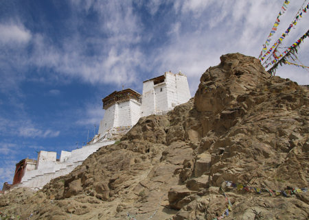 Tsemo Castle like an eagles nest enthroned above Leh and prayer flags, India.の写真素材