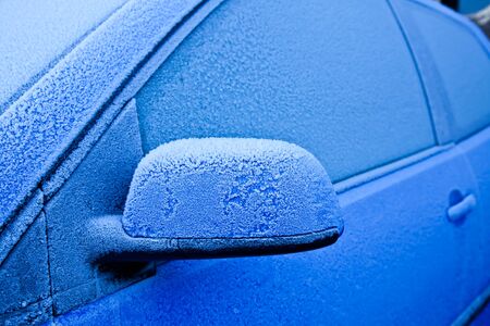 Ice on a blue car during winter season, good for conceptsの写真素材